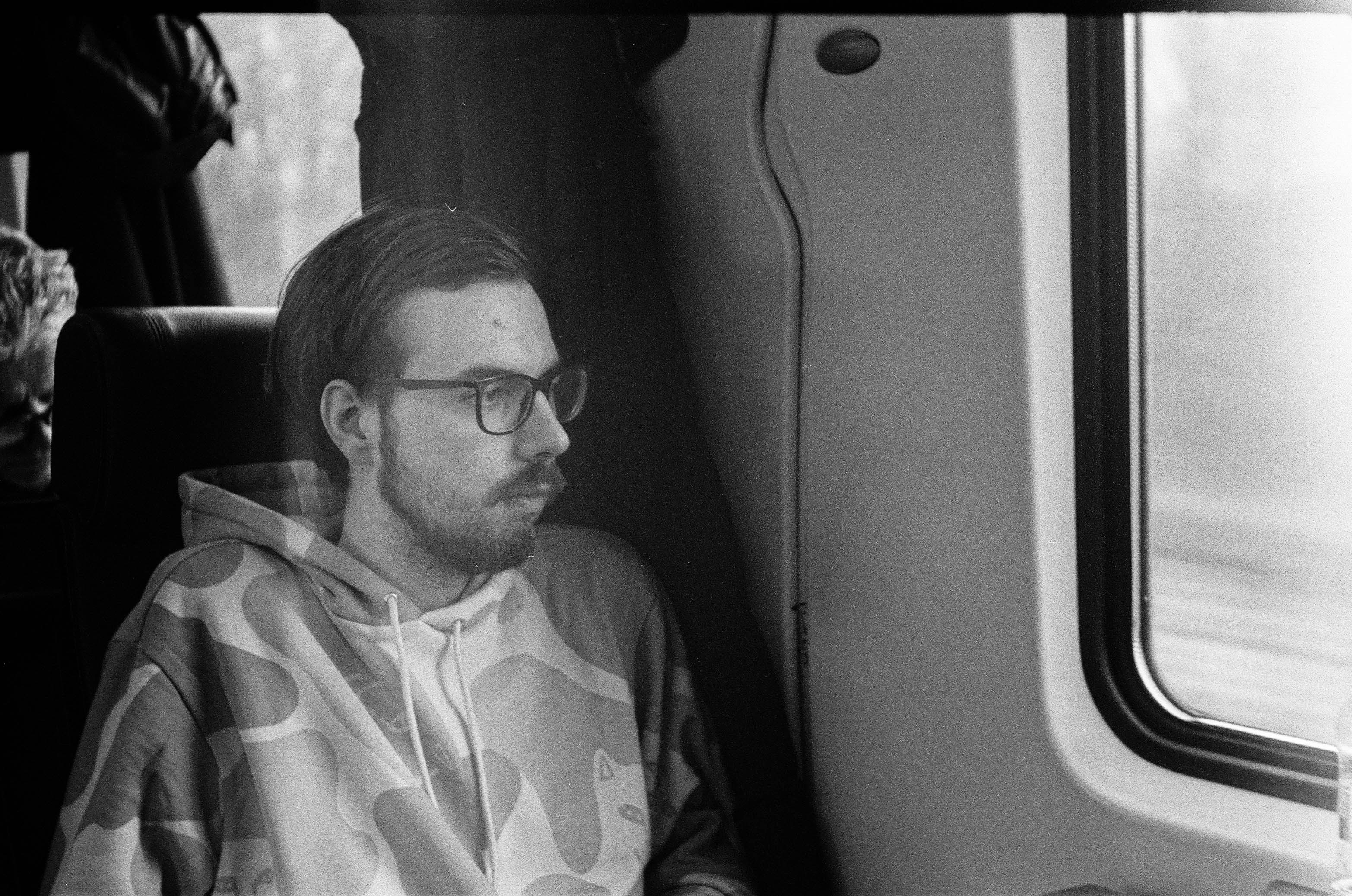 grayscale photo of man in eyeglasses and button up shirt